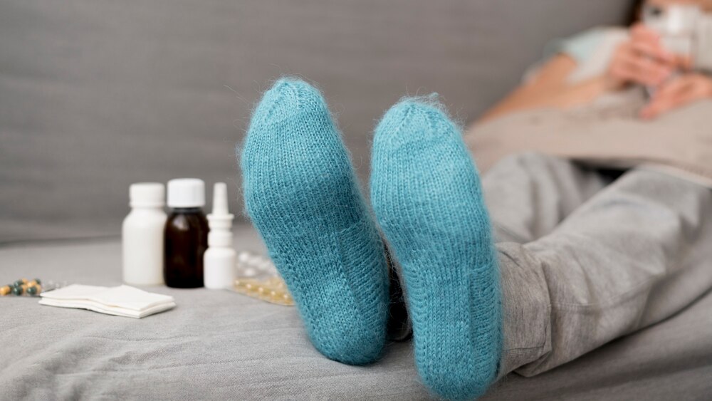 Close-up blue socks and blurred woman